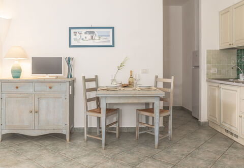 Casa D'orso Green Village Sardegna: Table, Cabinetry, Meubles, Propriété, Bâtiment, Bureau, Tiroir, Chaise, Éclairage, Bureau D'Ordinateur